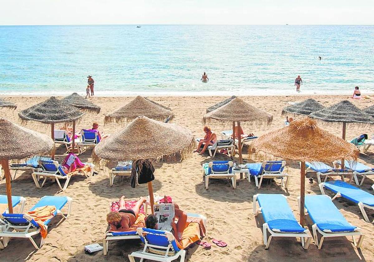 Tourists soak up the sun on a beach on the Costa del Sol.